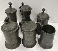 A collection of four 18th and 19th Century pewter tankards,