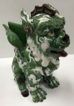 A green ground brown and white relief decorated Dog of Fo figural vase by Manuel Gustavo Bordallo