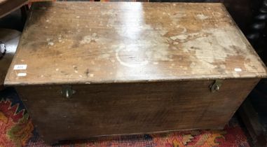 A late 19th / early 20th Century teak trunk of plain form, the top opening to reveal a candle box,
