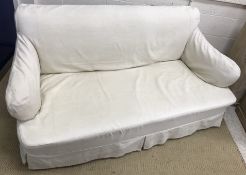 A circa 1900 upholstered sofa in the manner of Howard of London with curved side rails,