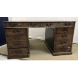 A mahogany double pedestal partners desk in the George III style,