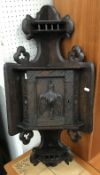 A late 19th Century oak Black Forest style corner cupboard with bird decoration to the door 38 cm