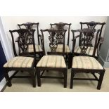 A set of six unusual mahogany dining chairs in the Chippendale taste,
