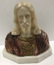 An alabaster carved figural bust of Christ with sacred heart motif at his breast,