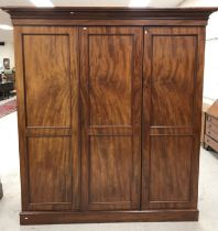 A 19th Century mahogany triple wardrobe compactum,