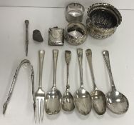 A collection of silverwares to include various tea spoons, a pair of sugar tongs, two napkin rings,