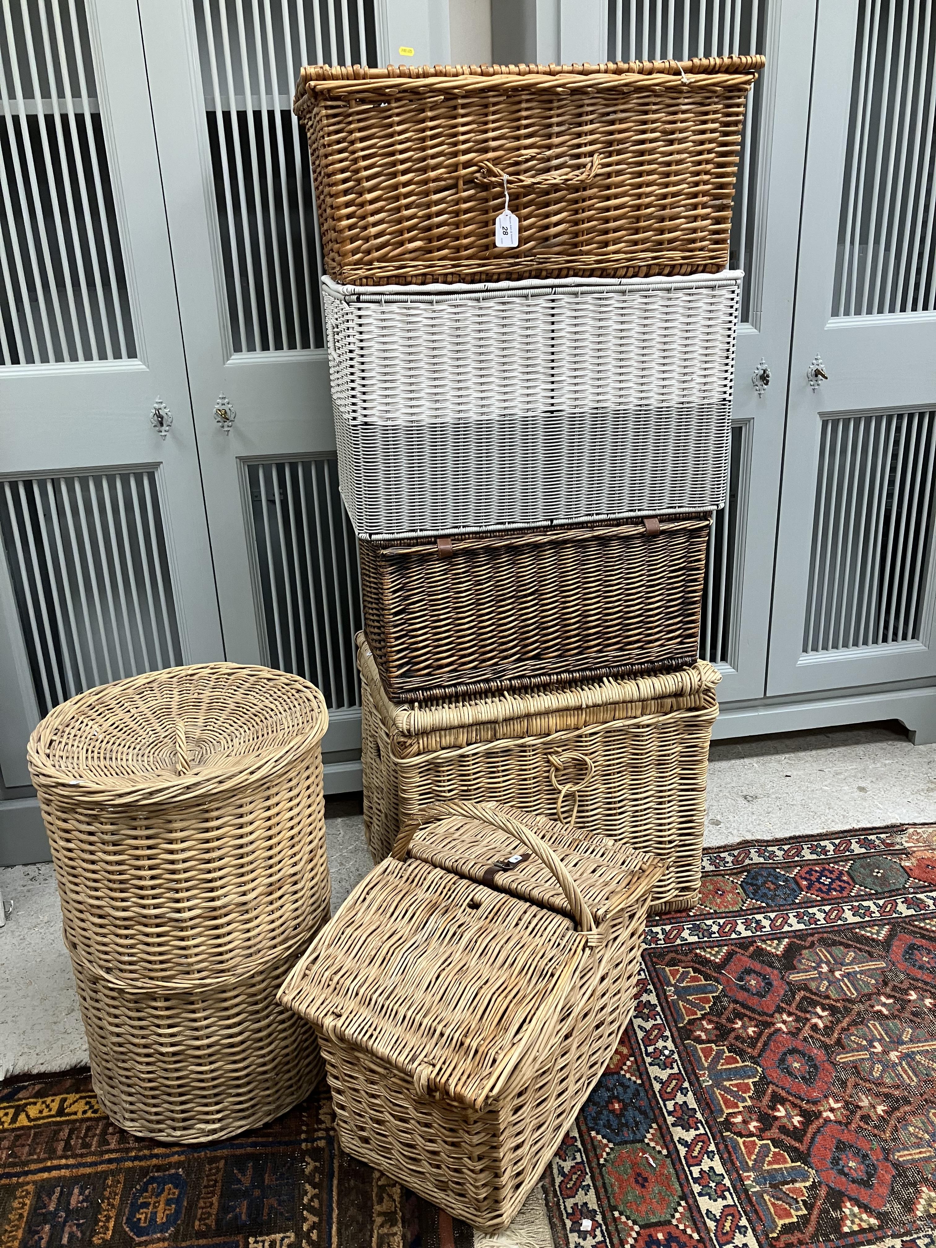 A collection of various wicker picnic and laundry hampers/baskets,