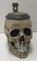 An early 20th Century E Bohne Sohne novelty character stein in the form of a skull resting on book