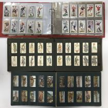 Three vintage albums of cigarette cards to include various mounted sets including British Orders &