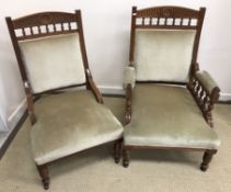 A pair of ladies and gent's Victorian walnut salon arm chairs with carved decorated and galleried