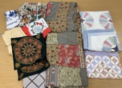 Two boxes of assorted textiles to include a pair of patchwork style quilts,