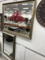 A modern gilt framed rectangular wall mirror with bevelled edge,