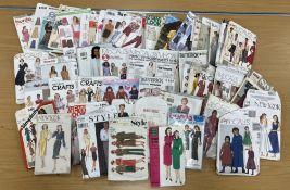 A box containing a quantity of vintage paper dress patterns mainly from the 1980s to include