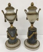 A pair of 19th Century alabaster, marble and gilt brass miniature urns on columns,