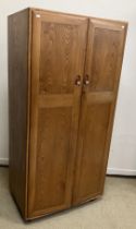 A 1960s Ercol elm two door wardrobe, Model 480-CSP38,