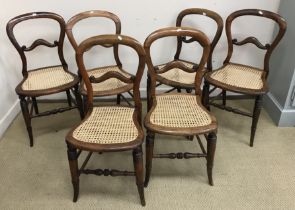 A set of six Victorian stained beech framed and caned kidney back dining chairs on turned and