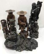 A collection of Oriental carved treenware figures,