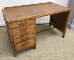 A mid 20th Century light oak single pedestal desk with bank of four drawers, 121.5 cm wide x 60.
