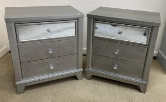 A pair of silver painted and mirrored simulated crocodile skin bedside chests of three drawers,