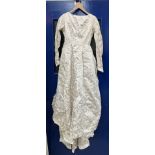 A lurex and satin mid 20th Century wedding dress with Princess seamed bodice and long sleeves,