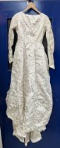A lurex and satin mid 20th Century wedding dress with Princess seamed bodice and long sleeves,