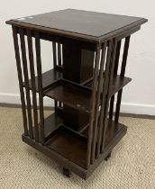 An early 20th Century oak revolving bookcase of typical form, 47 cm wide x 47 cm deep x 82.