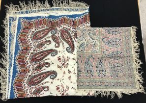 An early 20th Century paisley shawl together with a similar example in green,