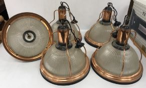 A set of five ribbed moulded glass copper framed ceiling lights in the early 20th Century