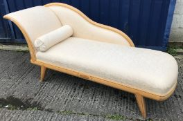 A modern beech framed and ebony strung chaise longue in the Regency taste on splayed square tapered