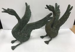 A pair of modern verdigris patinated bronze figures of geese with spread wings in the Meiji period
