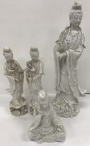 A 19th Century Chinese blanc de chine figure of Guanyin 44 cm high together with two further blanc