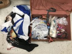 A leather suitcase containing various studded belts,