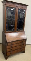 An Edwardian mahogany and inlaid bureau bookcase,