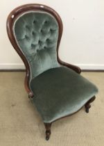 A Victorian mahogany framed salon chair with buttoned upholstered back on cabriole front legs to