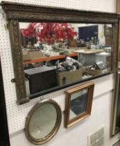 A 19th Century gilt framed over mantel mirror with rectangular plate 61 cm long x 108 cm wide x 6