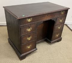 A late George III oak desk,