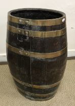 A 19th Century oak and brass bound coopered oak barrel of oval form as a stick stand approx.