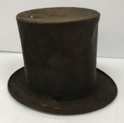 A mid 19th Century brown velvet stove pipe style top hat with ribbon and buckle to base,