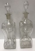 A pair of 19th Century engraved and etched glass waisted glug glug decanters,