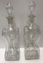 A pair of 19th Century engraved and etched glass waisted glug glug decanters,