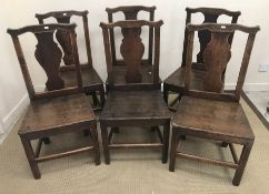 A set of six 19th Century Provincial oak vase back panel seated dining chairs on square moulded