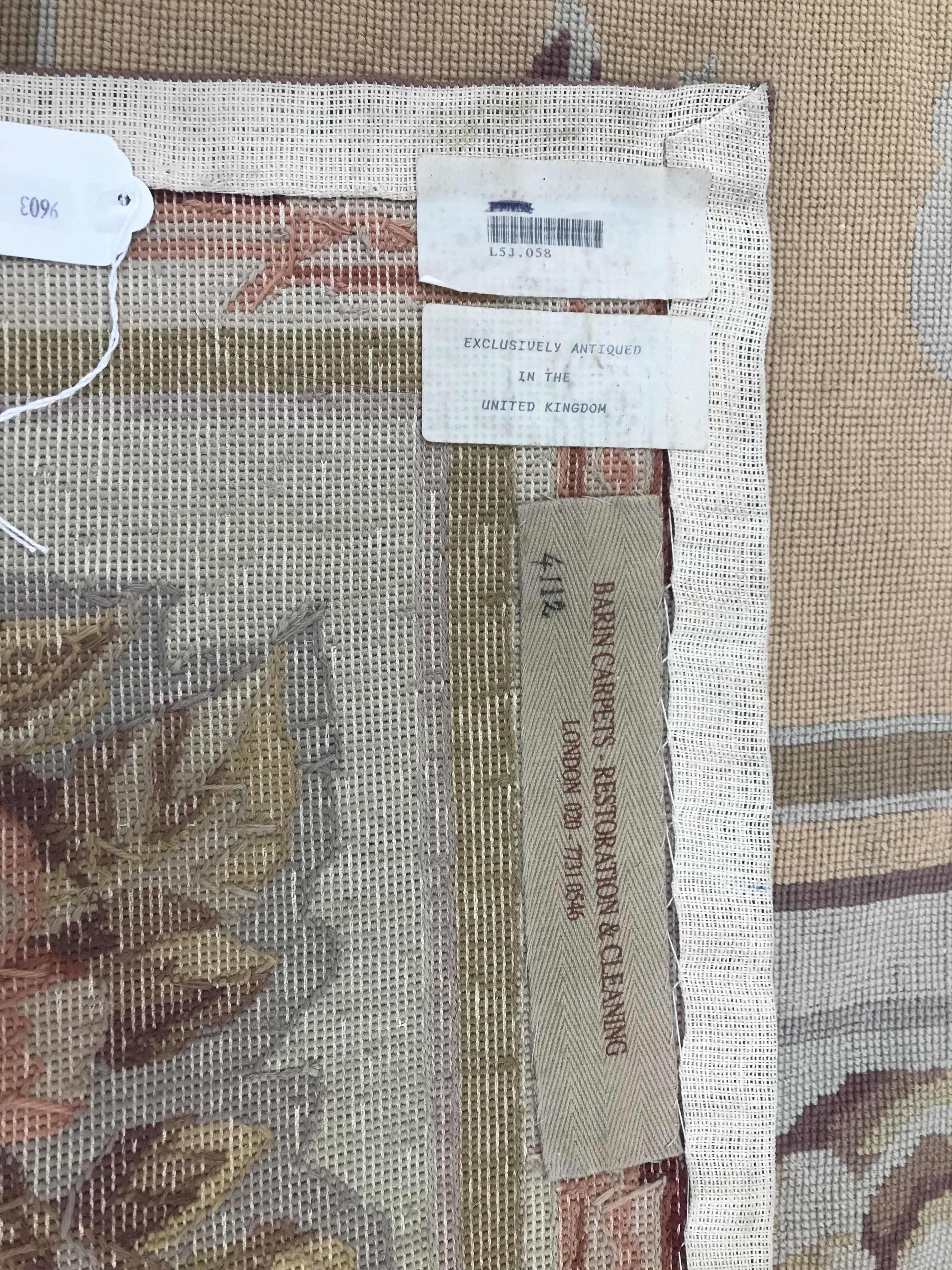 A needlepoint rug, the peach ground set with scrolling foliate design within a stepped border, - Image 9 of 9