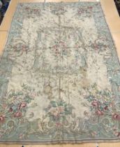 A crewelwork carpet/panel, the cream and green ground set with scrolling foliate design approx.