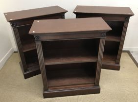 A set of three modern reproduction mahogany open bookcases in the 19th Century manner,