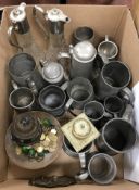 A box containing assorted pewter tankards together with a brass inkwell,