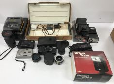 A collection of various photographic equipment to include a Minolta Riva AF35C camera,