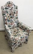 A 19th Century upholstered high back armchair on slender turned tapering front legs to pad feet,