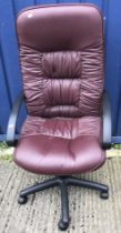 A modern burgundy leatherette upholstered adjustable swivel office chair