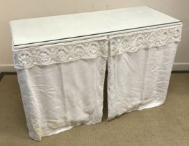 A white painted square fronted dressing table with cotton drapes 119 cm wide x 49 cm deep x 76.