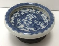 A Chinese blue and white dish, the centre field decorated with five toed dragon chasing a pearl,
